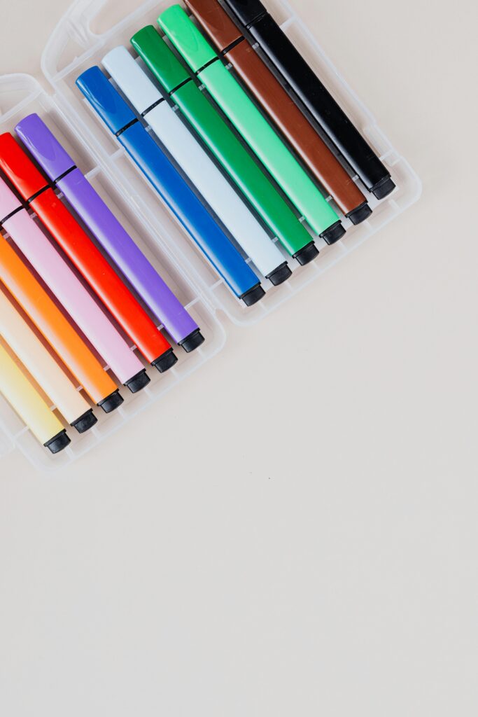 Top view of a colorful marker set arranged neatly on a white background, ideal for school or office use.